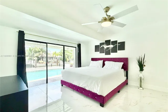 a bedroom with a large bed and a large window