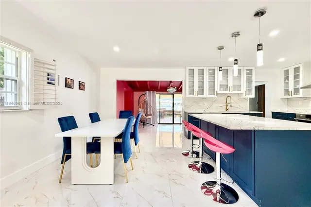 a dining room with a table and chairs