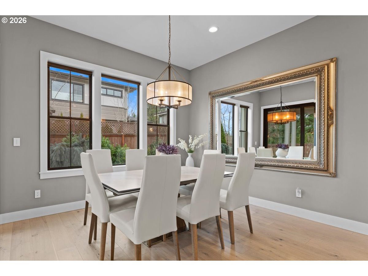 7405 Southwest 77th Avenue Portland, OR 97223 - Photo 15 of 47 a view of a dining room with furniture large windows and wooden floor
