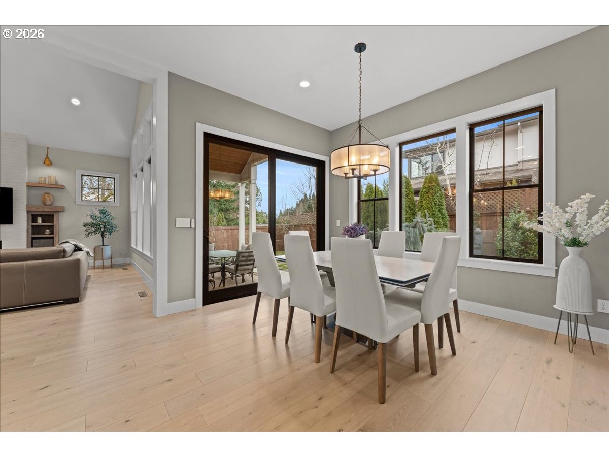 7405 Southwest 77th Avenue Portland, OR 97223 - Photo 16 of 47 a dining room with furniture a chandelier and wooden floor