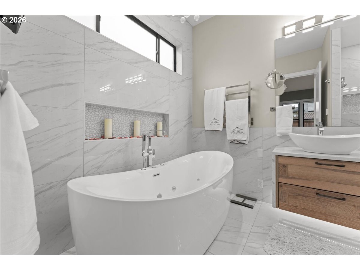 7405 Southwest 77th Avenue Portland, OR 97223 - Photo 22 of 47 a bathroom with a sink a mirror and a bathtub