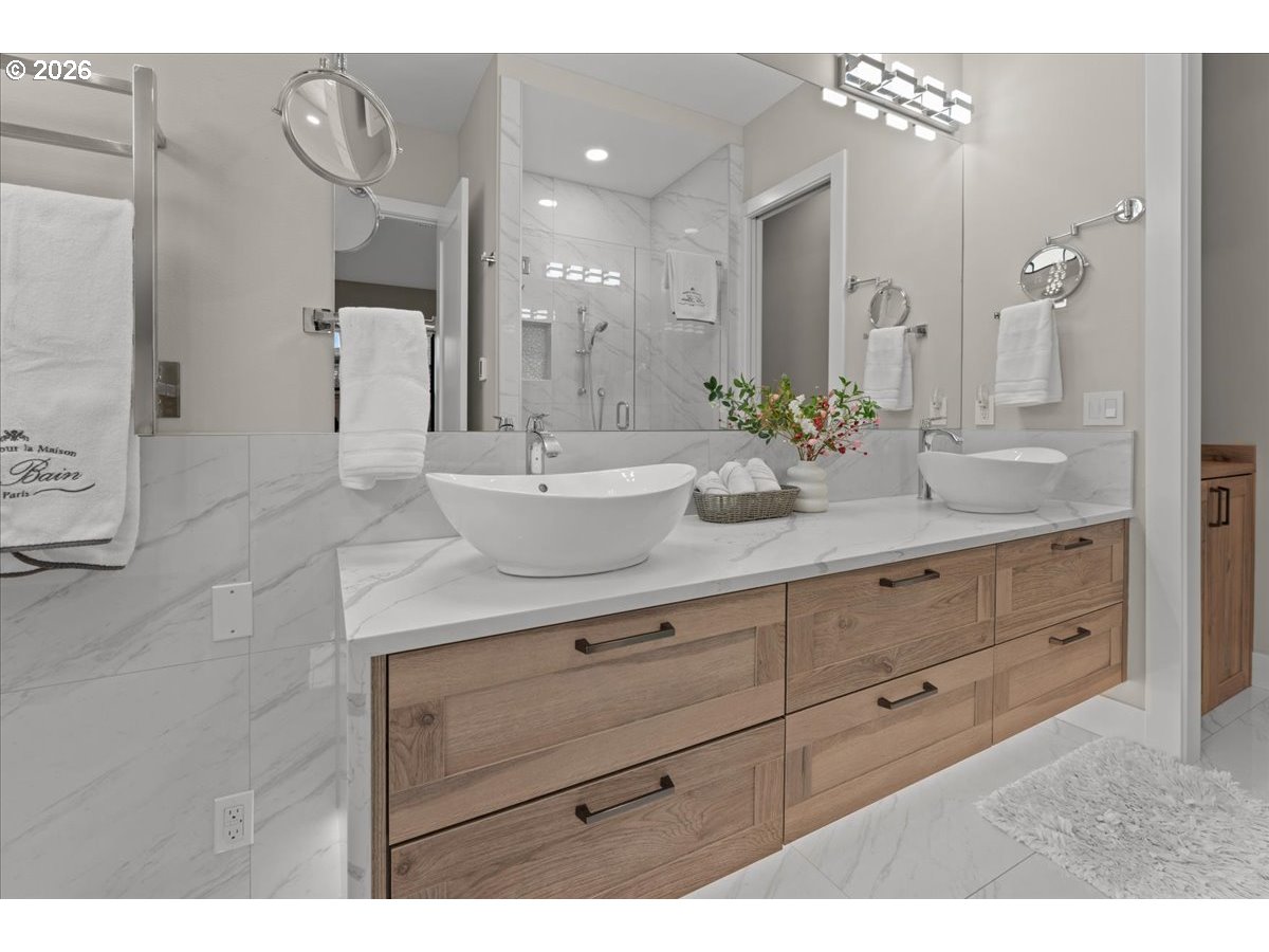 7405 Southwest 77th Avenue Portland, OR 97223 - Photo 23 of 47 a spacious bathroom with a granite countertop sink a mirror and a shower