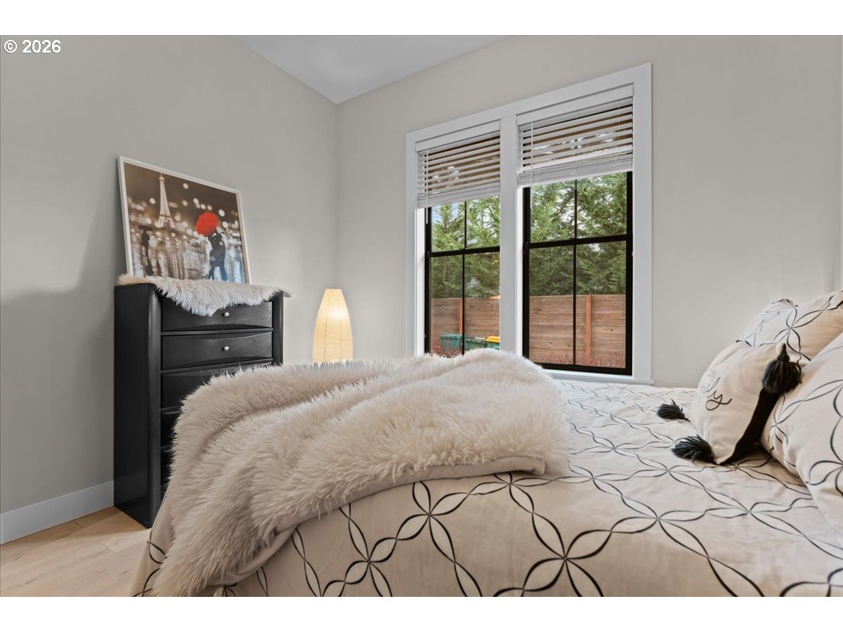 7405 Southwest 77th Avenue Portland, OR 97223 - Photo 30 of 47 a bedroom with a bed and a large window