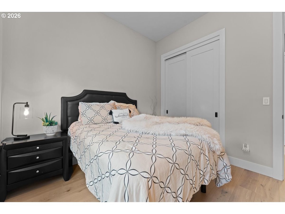 7405 Southwest 77th Avenue Portland, OR 97223 - Photo 31 of 47 a bedroom with a bed and a night stand