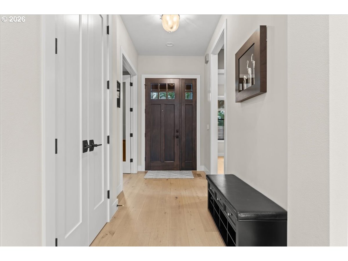 7405 Southwest 77th Avenue Portland, OR 97223 - Photo 4 of 47 a view of a hallway with wooden floor and a bathroom