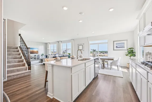 a kitchen with lots of counter top space a sink appliances and cabinets