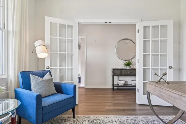 a living room with furniture a rug and a window