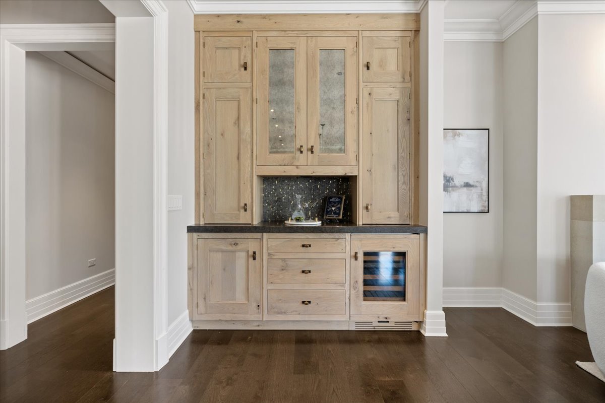 9 West Walton Street, Unit 702 Chicago, IL 60610 - Photo 12 of 38 a view of white cabinets and wooden floor