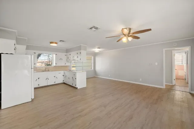a view of a kitchen with a sink and a refrigerator