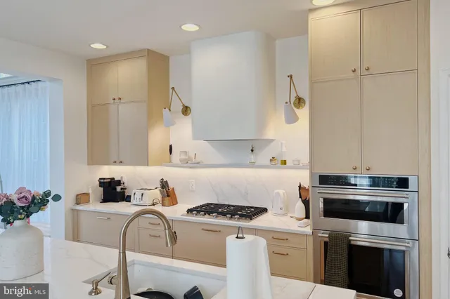 a kitchen with a stove and white cabinets