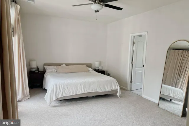 a bedroom with a bed and a mirror