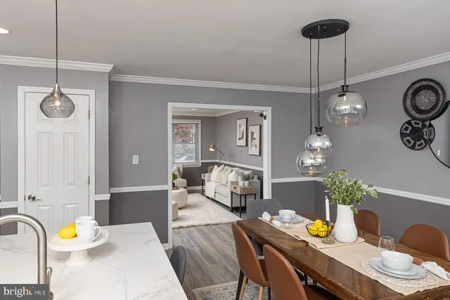 a view of a dining room with furniture and chandelier