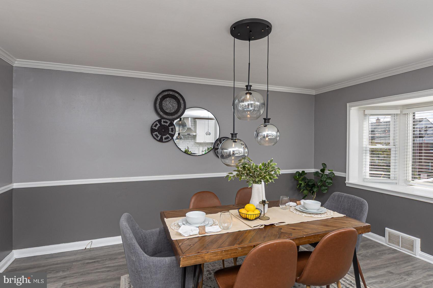 1809 Northbourne Road Baltimore, MD 21239 - Photo 13 of 43 a dining room with a table and chairs