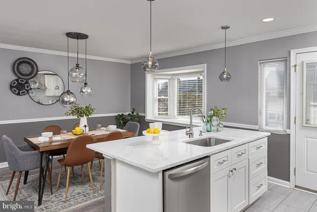 a kitchen with a sink appliances and a table