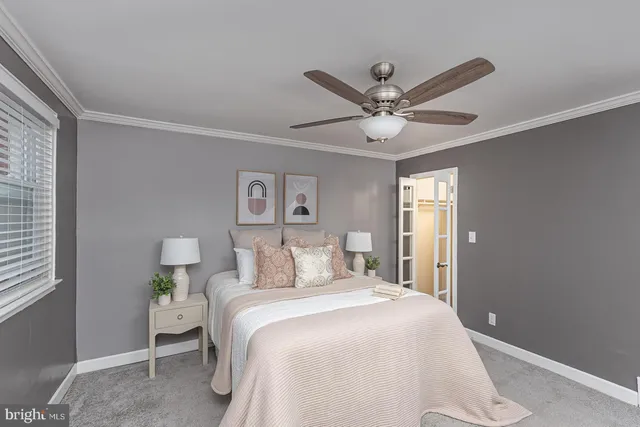 a bedroom with a bed and a ceiling fan
