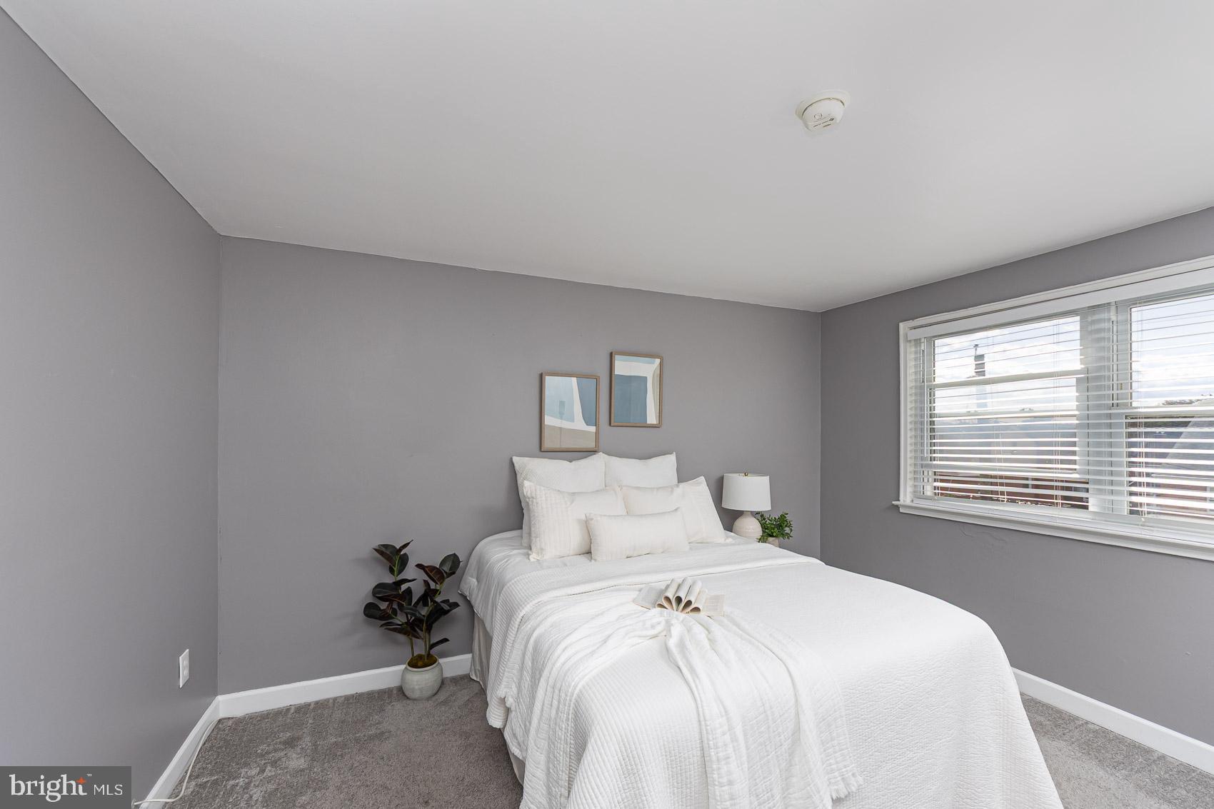 1809 Northbourne Road Baltimore, MD 21239 - Photo 23 of 43 a bedroom with a bed and a window