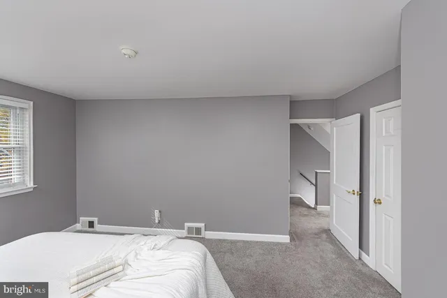 a room with a bed and a view of bathroom