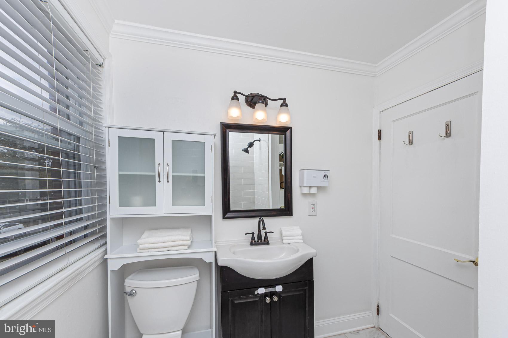 1809 Northbourne Road Baltimore, MD 21239 - Photo 26 of 43 a bathroom with a toilet sink and mirror