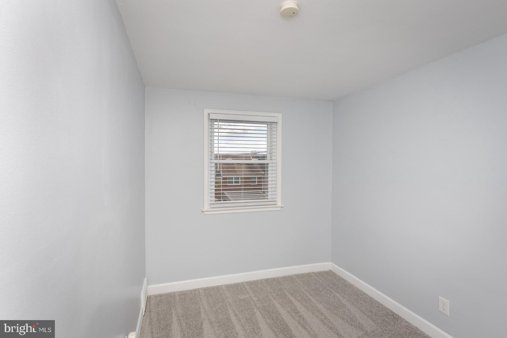 1809 Northbourne Road Baltimore, MD 21239 - Photo 29 of 43 a view of an empty room with wooden floor and a window