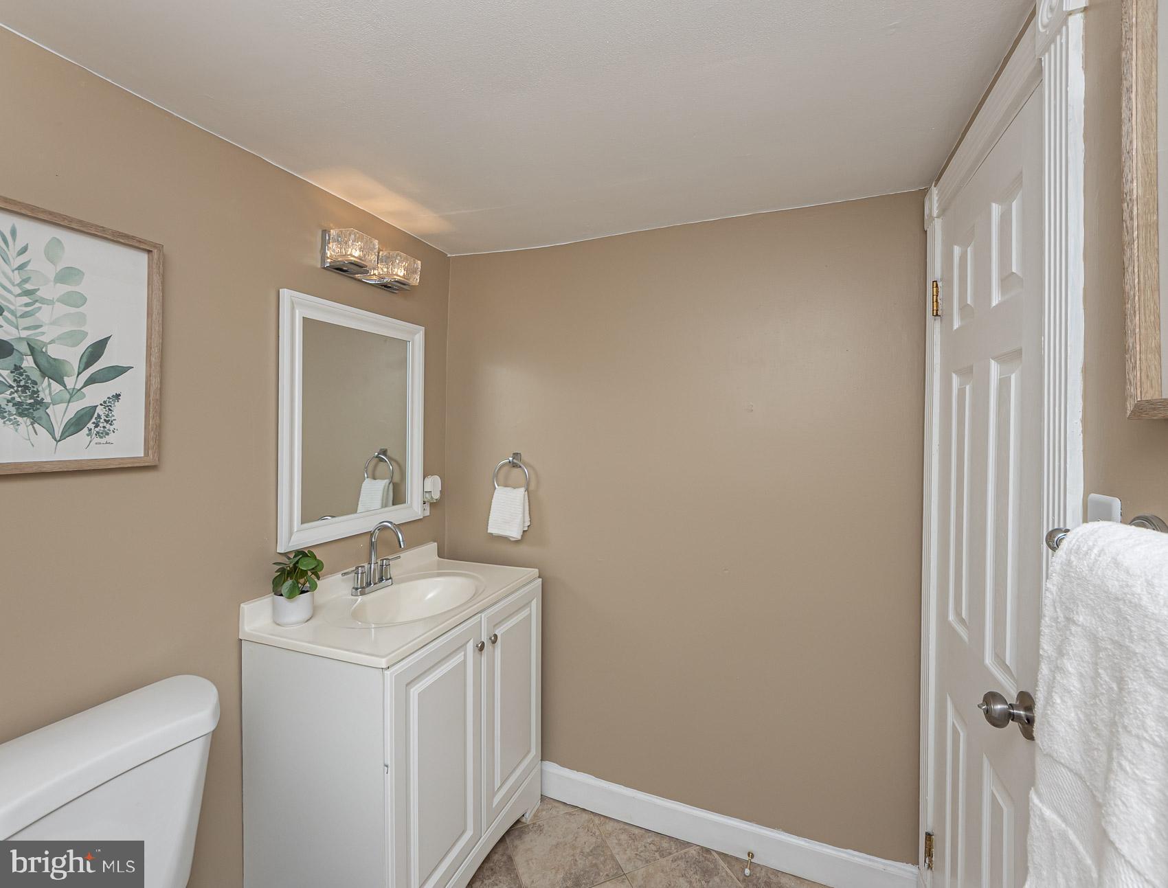 1809 Northbourne Road Baltimore, MD 21239 - Photo 37 of 43 a bathroom with a sink a toilet and mirror