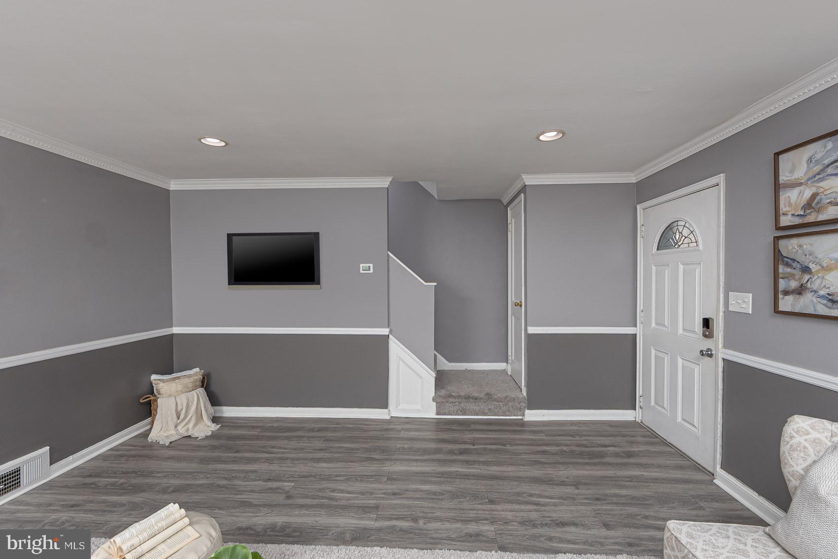 1809 Northbourne Road Baltimore, MD 21239 - Photo 9 of 43 a view of empty room with wooden floor and windows
