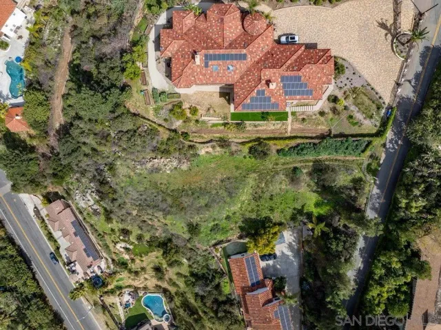 a view of a yard with wooden fence