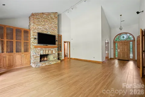 a view of a livingroom with a fireplace a flat screen tv and a fireplace