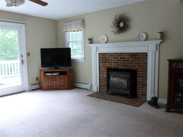 245 Lake Road Ashburnham, MA 01430 - Photo 5 of 22 a living room with furniture and a fireplace