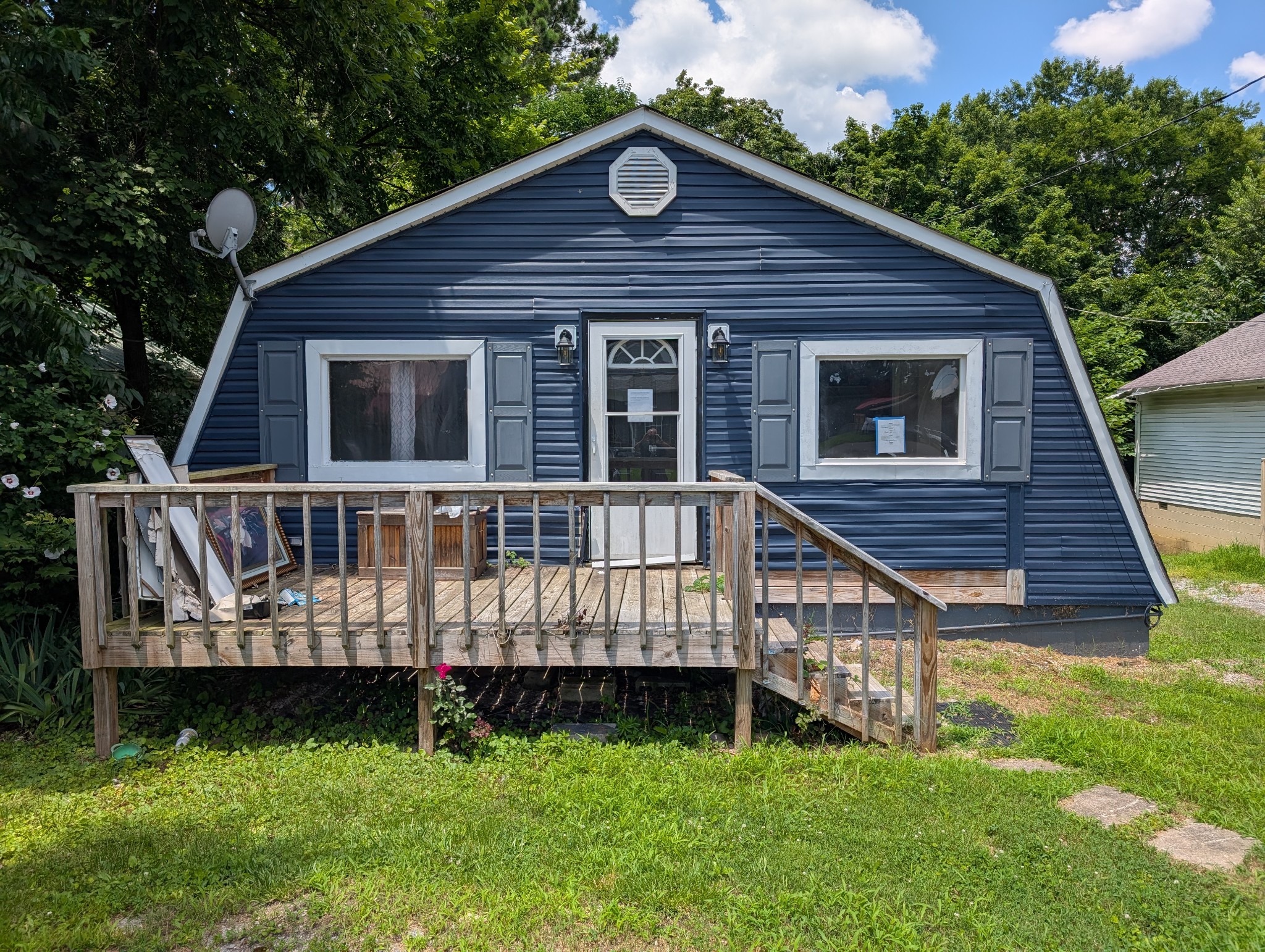 a view of front of house with a deck