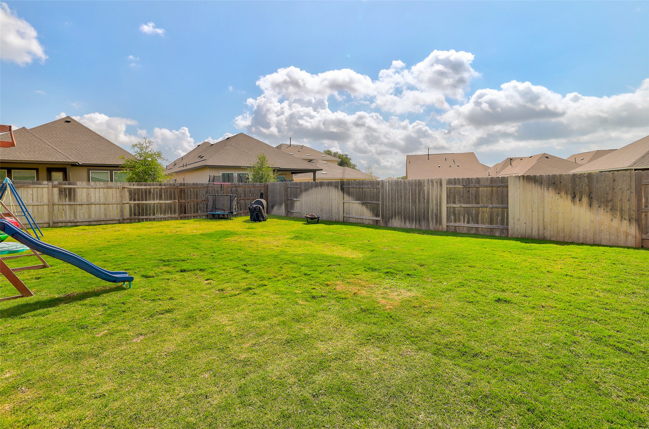 112 Rocking R Court Georgetown, TX 78633 - Photo 36 of 40 A fenced backyard offers a lush, grassy expanse, ideal for outdoor enjoyment and privacy.