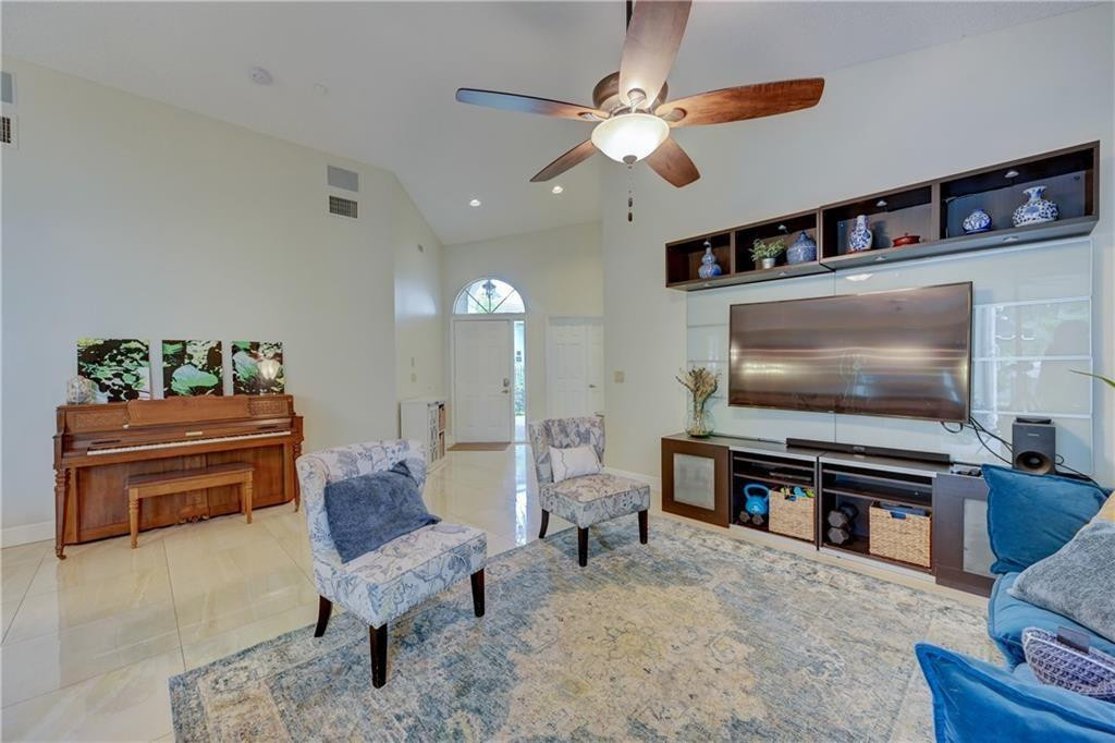 8171 Hampton Wood Drive Boca Raton, FL 33433 - Photo 7 of 56 a living room with furniture and a flat screen tv