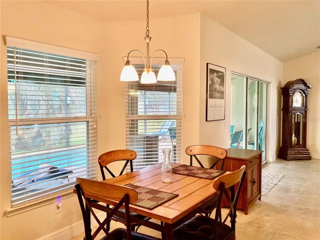 a view of a dining room with furniture and chandelier