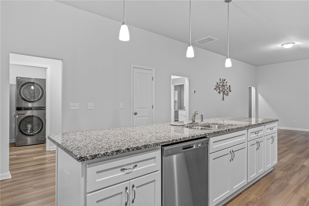 24 Chalet Court Anderson, SC 29621 - Photo 11 of 39 This modern kitchen features a spacious island with granite counters, ideal for culinary creations and entertaining.