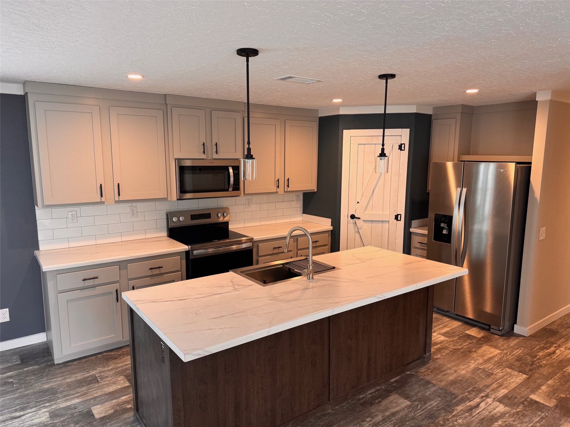 273535 Murrhee Road Hilliard, FL 32046 - Photo 12 of 25 a kitchen with stainless steel appliances a stove refrigerator sink and microwave