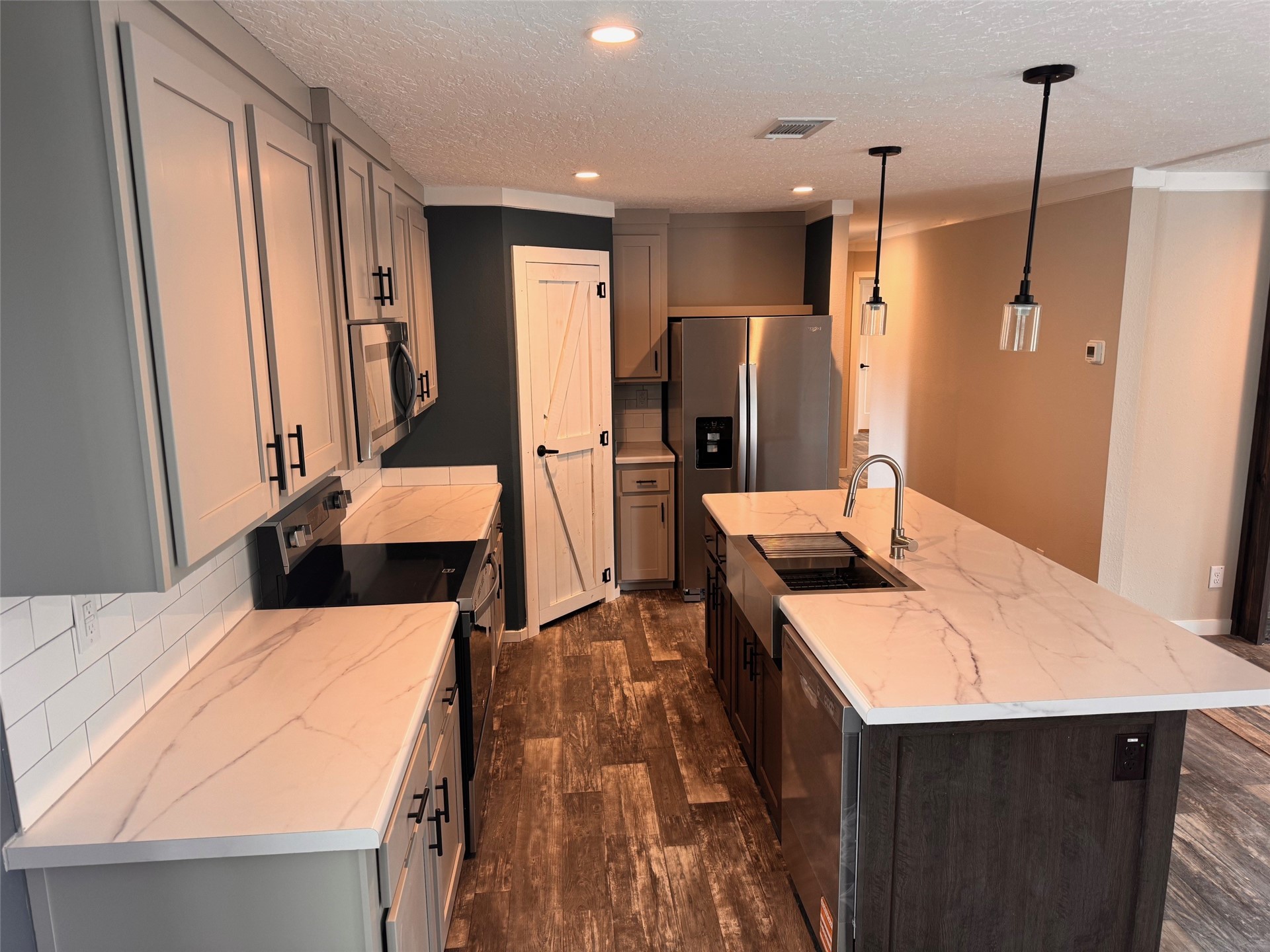273535 Murrhee Road Hilliard, FL 32046 - Photo 13 of 25 a kitchen with a sink a counter top space and stainless steel appliances