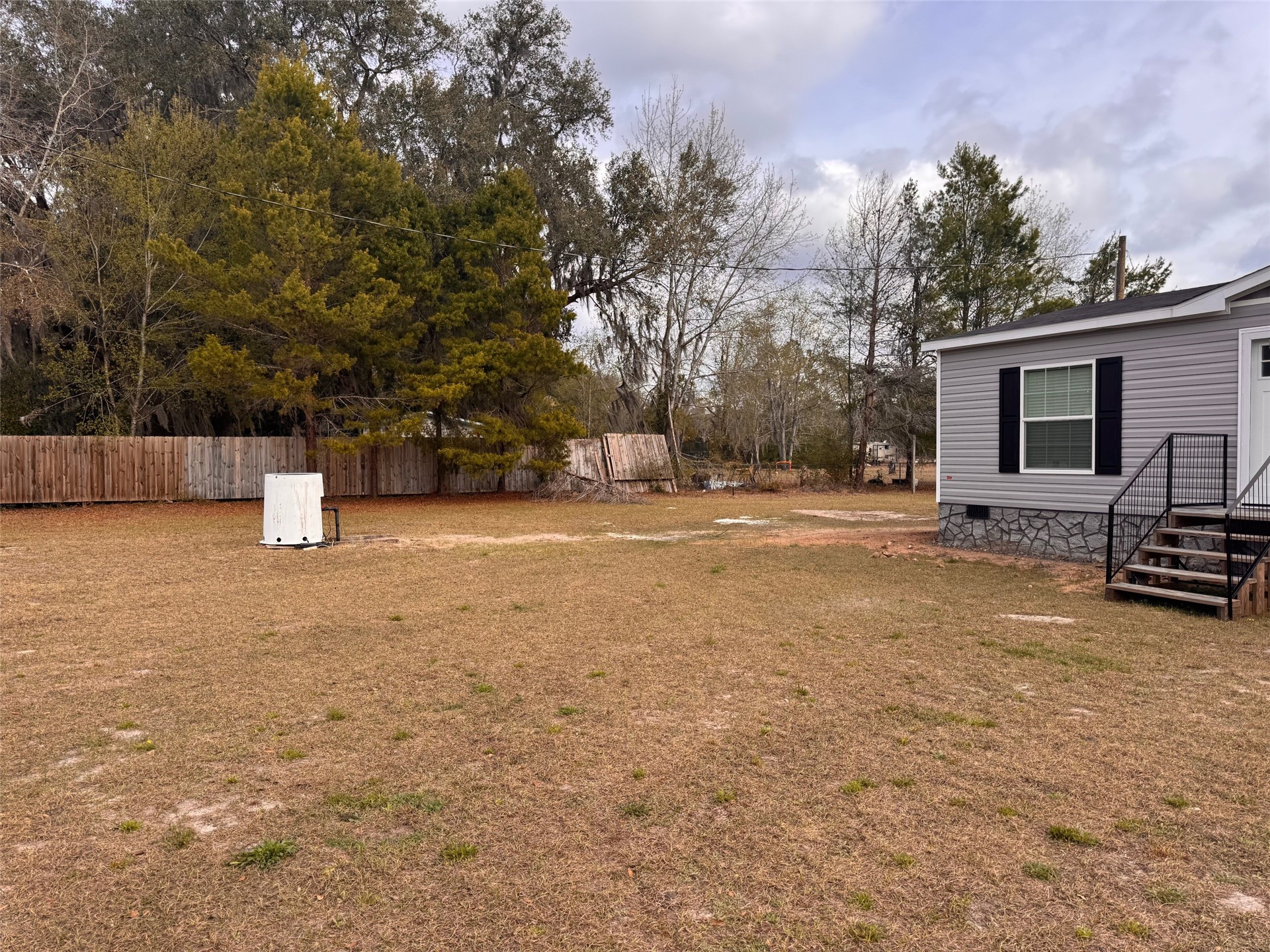 273535 Murrhee Road Hilliard, FL 32046 - Photo 2 of 25 a backyard of a house with barbeque oven and trees