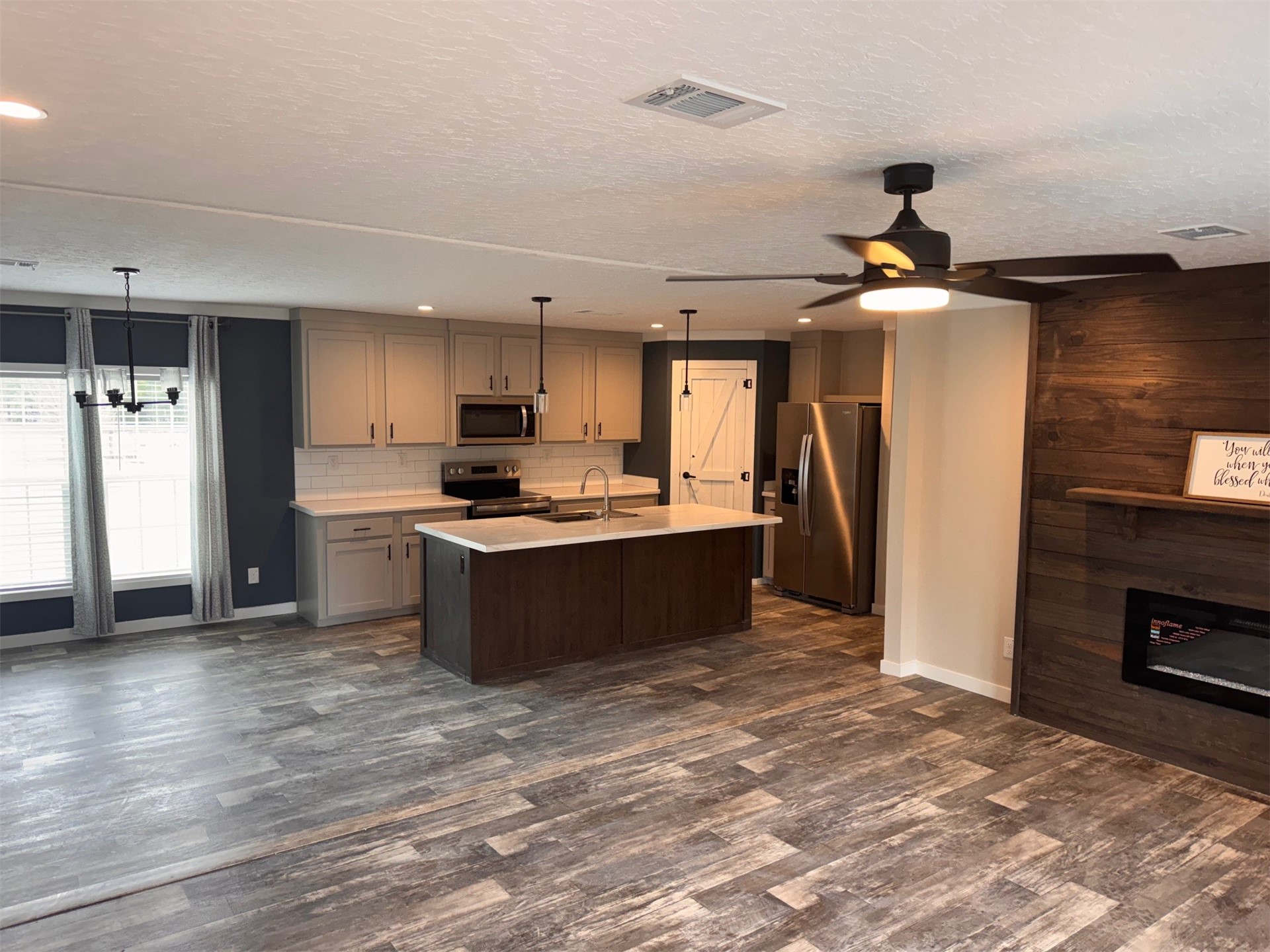 273535 Murrhee Road Hilliard, FL 32046 - Photo 9 of 25 a kitchen with stainless steel appliances kitchen island granite countertop a refrigerator a sink a stove a microwave and island