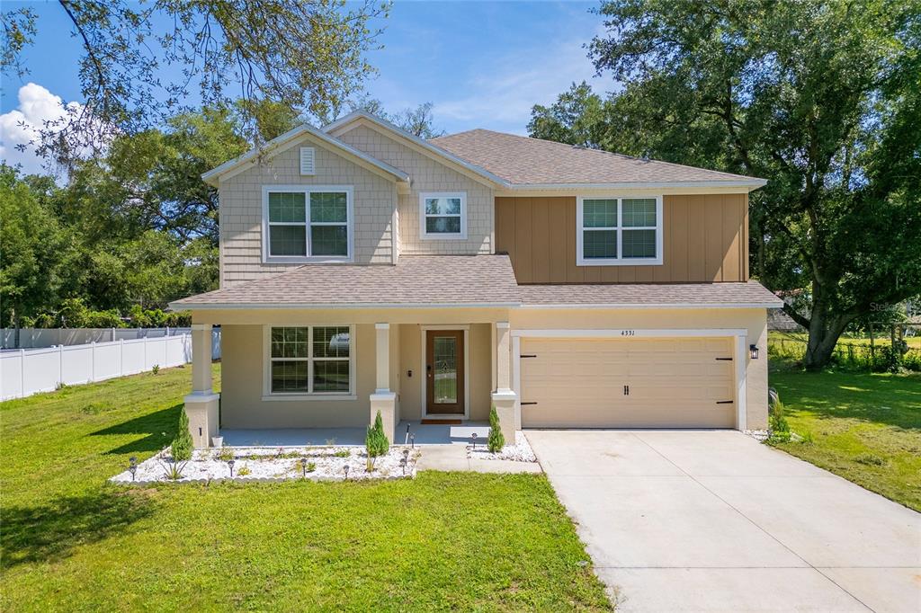4331 Wayne Road Fruitland Park, FL 34731 - Photo 1 of 46 a view of a house with a yard and a large tree
