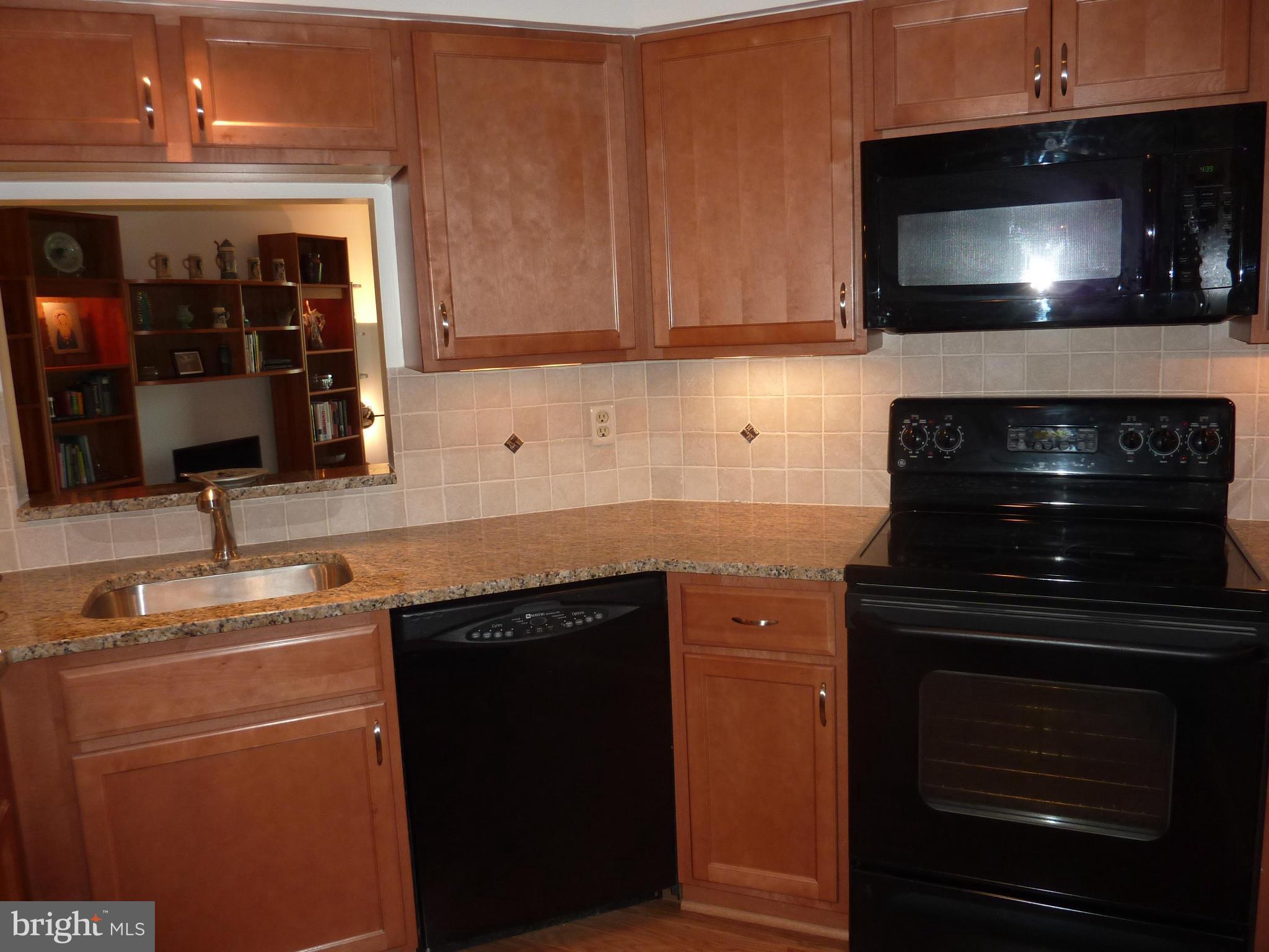 11300 Harbor Court, Unit 113 Reston, VA 20191 - Photo 5 of 26 Kitchen with "window" to Living room