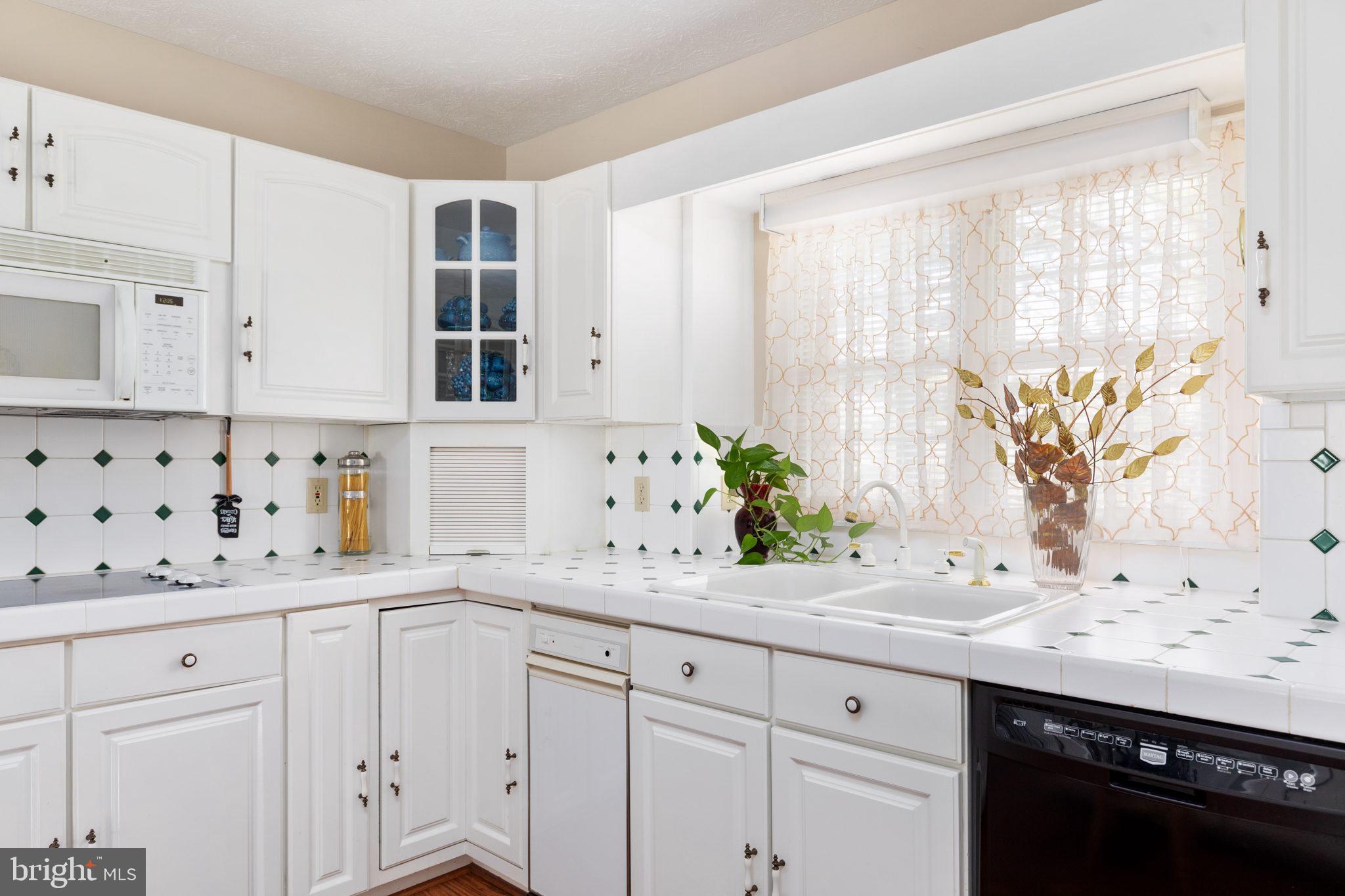 317 Anderson Road Basye, VA 22842 - Photo 6 of 51 a bathroom with a granite countertop sink a potted plant and a window