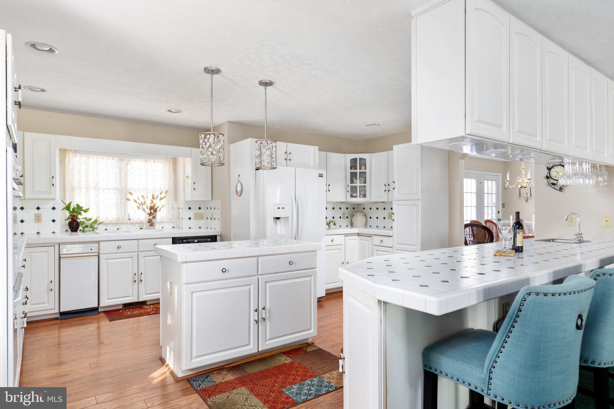 317 Anderson Road Basye, VA 22842 - Photo 8 of 51 a kitchen with granite countertop white cabinets and chairs