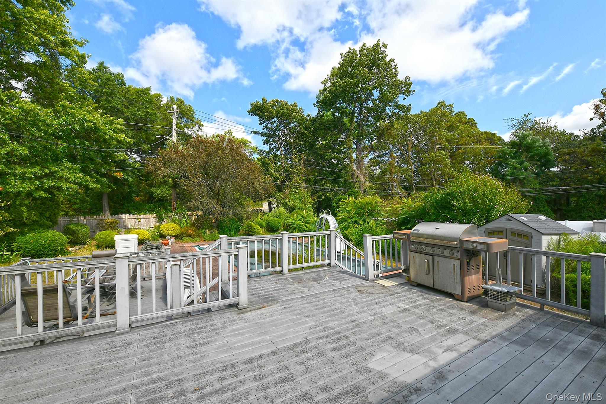 105 Roxton Road Plainview, NY 11803 - Photo 24 of 28 a view of a deck and yard with green space