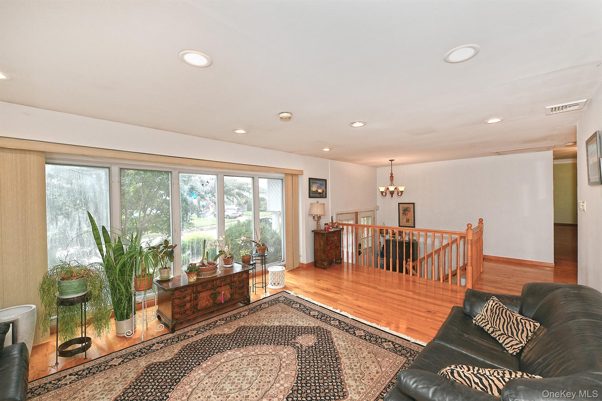 105 Roxton Road Plainview, NY 11803 - Photo 6 of 28 a living room with furniture and a dining table with garden view