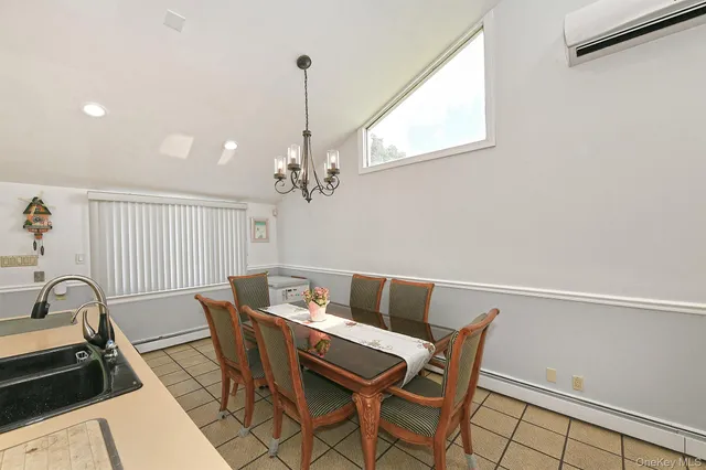 a view of a dining room with furniture and a window