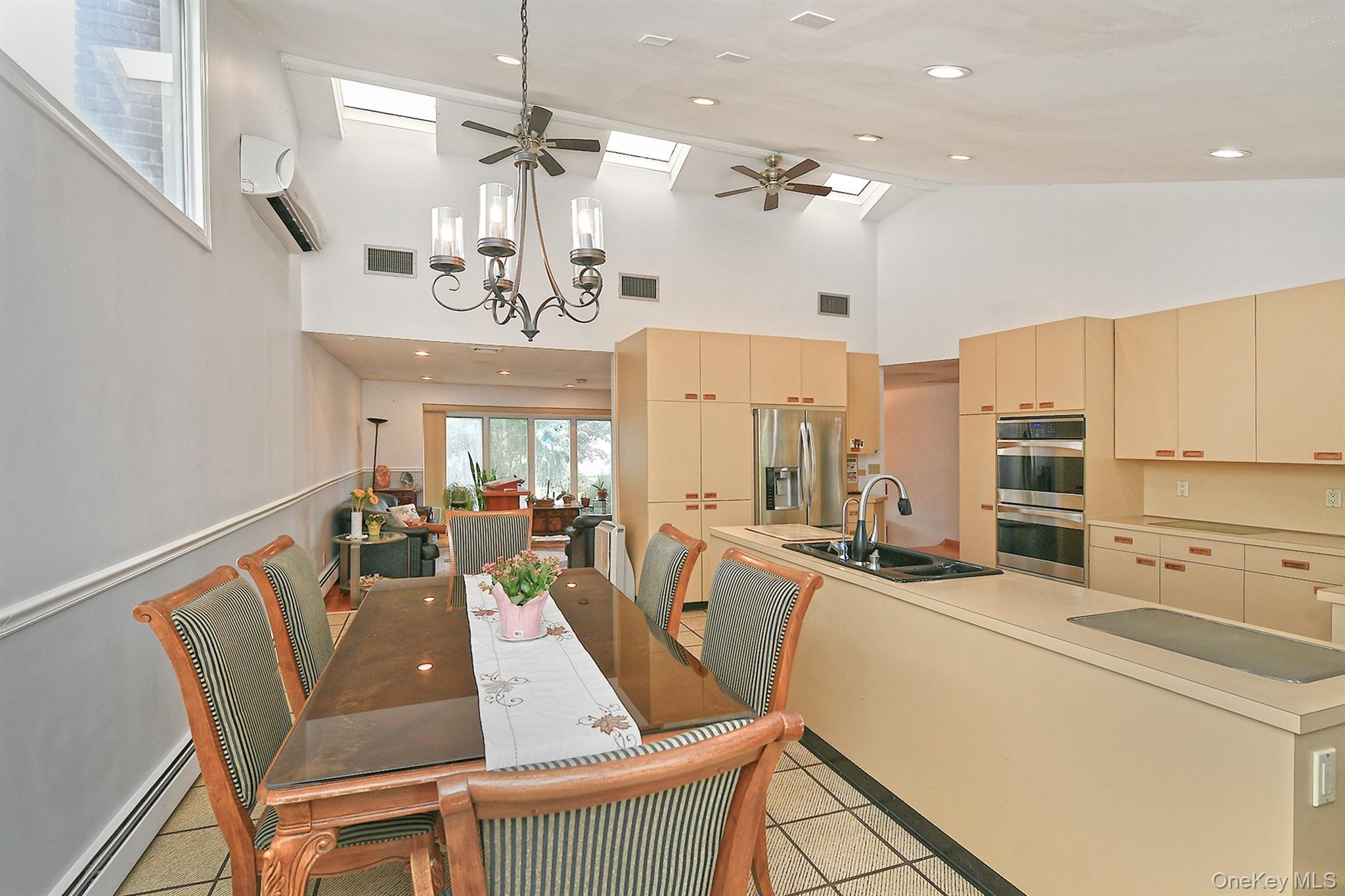 105 Roxton Road Plainview, NY 11803 - Photo 9 of 28 a living room with furniture a chandelier and a chandelier