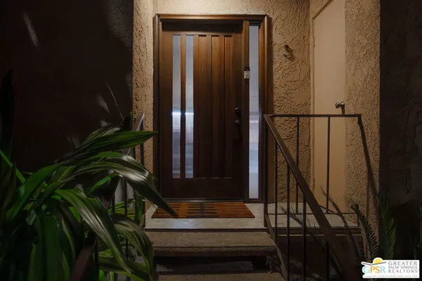 a view of entryway with wooden floor and stairs