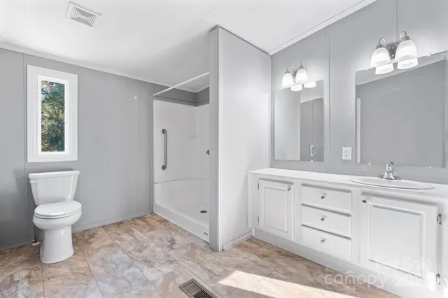 a bathroom with a toilet sink and a mirror