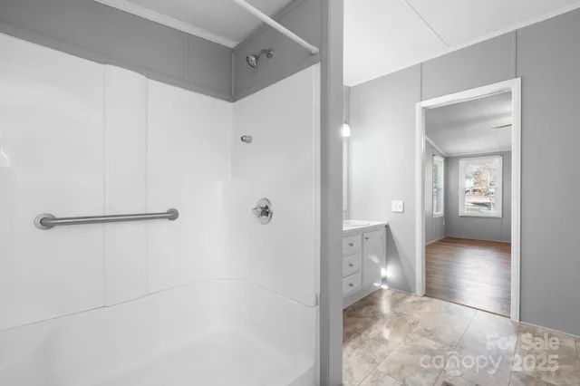 a view of a bathroom with a shower and a bath tub