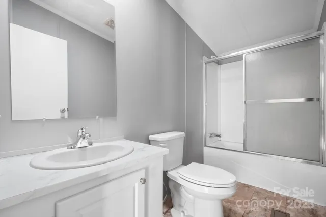 a bathroom with a sink toilet and a mirror