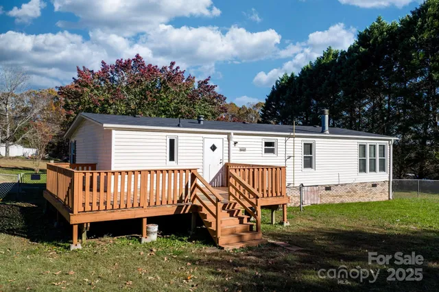 a view of a house with a yard and sitting area